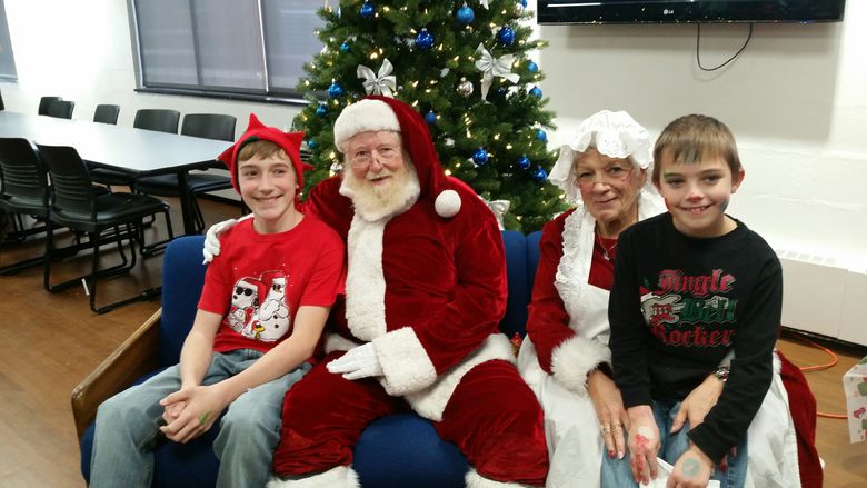 Santa and Mrs. Clause visit with children. 