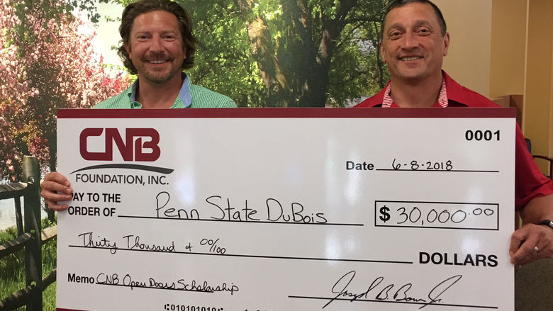 CNB President Joe Bower, right, presents a $30,000 check