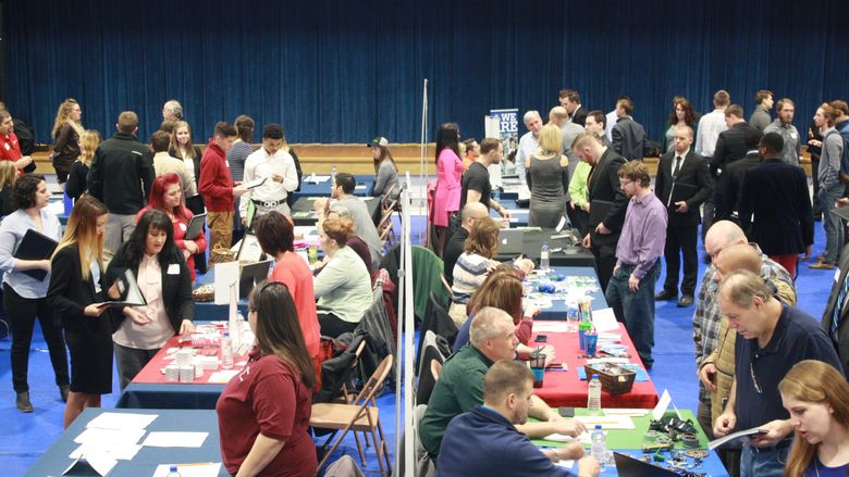 Jobseekers interact with employers during last year's career fair in the campus gymnasium.  