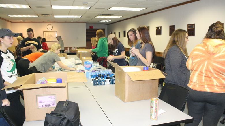 Students work to assemble Thanksgiving care packages. 