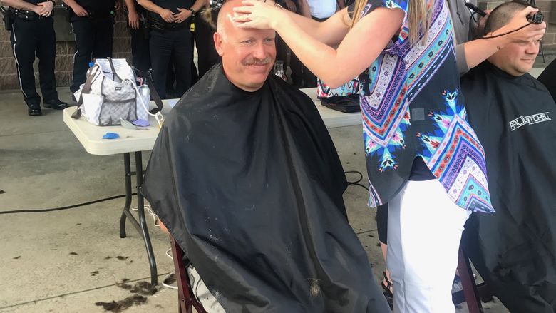 Campus police officer John Licatovich gets a buzz cut for "Buzz for Brock"