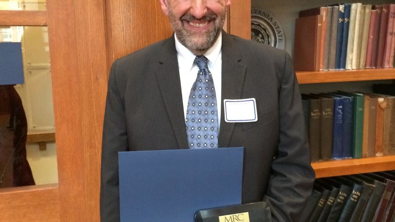 Robert Loeb with his 2015 John Romano Faculty/Staff Diversity Recognition Award. 