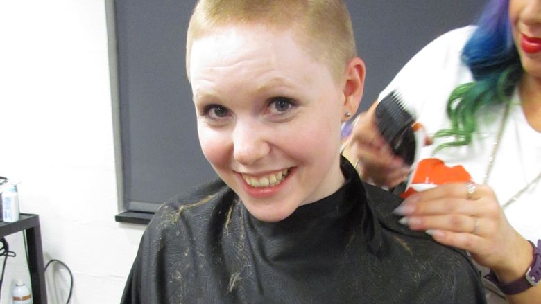 Student Amber Metzger goes under the shears to have her head shaved for THON. 