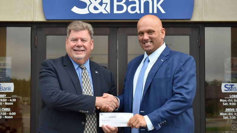 Chancellor M. Scott McBride accepts a check from S&T Bank’s Daniel Baronick.