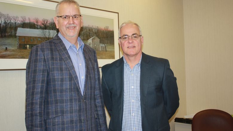 Mike Nesbit, vice president and personal lines manager, at left, with George Heigel, president. 