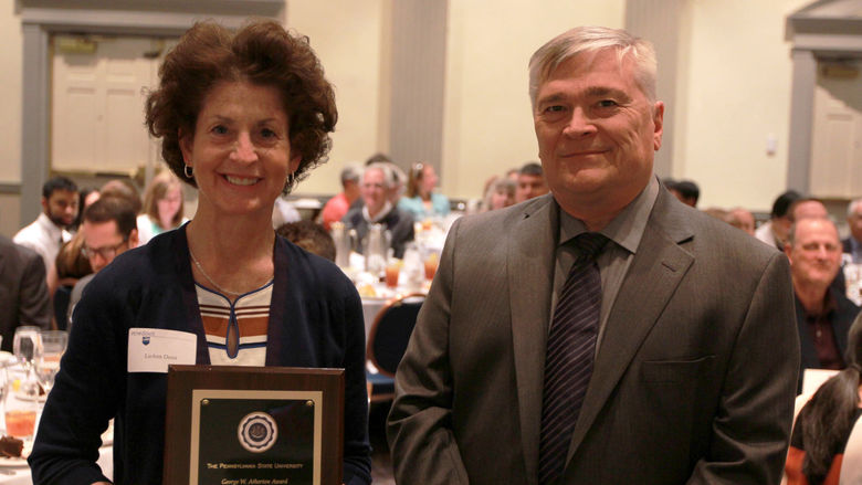 Luann Demi received her award from Penn State President Eric Barron. 