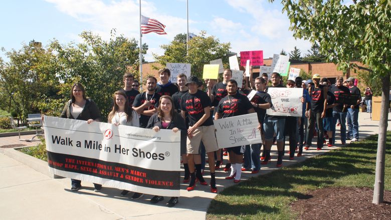 Men prepare to step off for Walk a Mile in Her Shoes. 