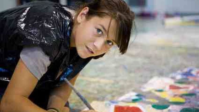 Girl painting a picture on the floor