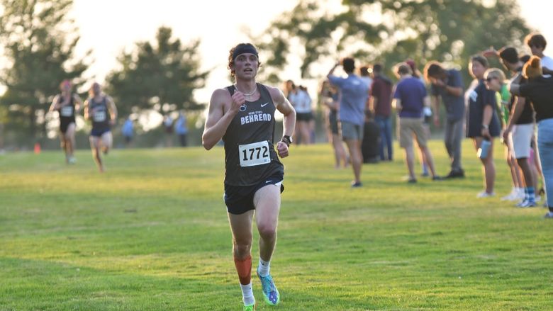 A Penn State Behrend runner competes in a cross country race.