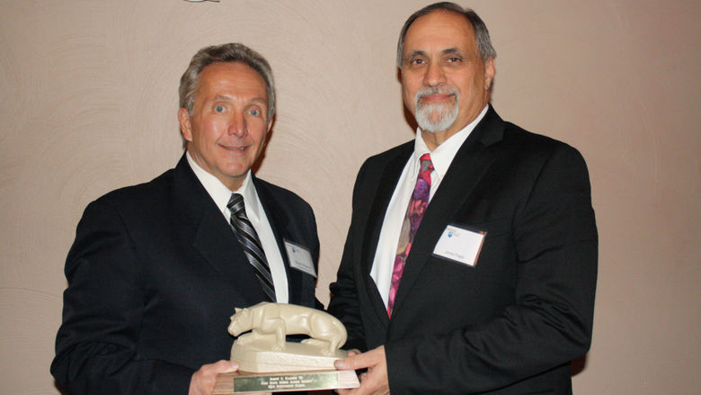Bob Ellinger '80 receives the the Outstanding Alumni Award from Jim Fragle