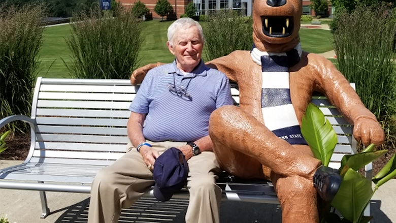 Charles E. Hunnell poses at the Penn State Fayette Lion Bench