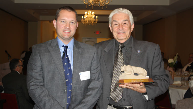 Ronald Santini '71 receiving the Livetime Achievement Award from Chris Santini '02