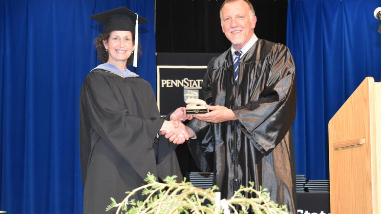 Assistant Teaching Professor LuAnn Demi receives her DEF Educator of the Year Award from DEF president Craig Ball