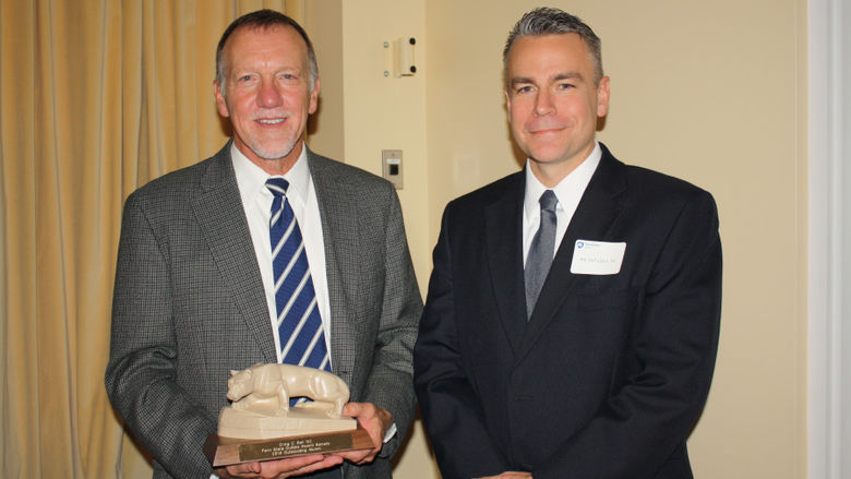 Craig Ball '82 receiving the Outstanding Alumni Award from Bill McFadden