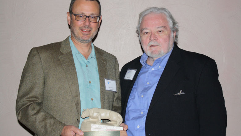 Craig Pearce '87 accepting the 2014 Outstanding Alumni Award from Henry Sims