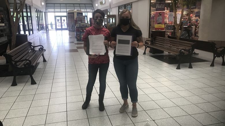 Students, Tamara Seltzler, left, and Paige Pleta distributing surveys to members of the community at the DuBois Mall. 