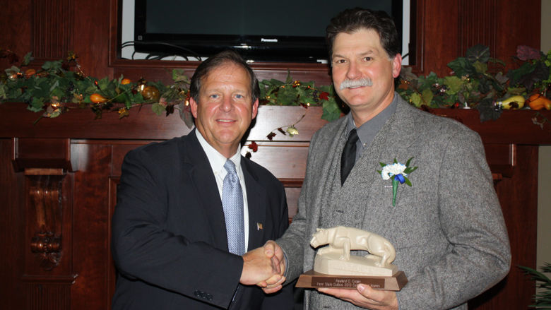 Rawland D. Cogan receiving the 2013 Outstanding Alumni Award from David Spigelmyer