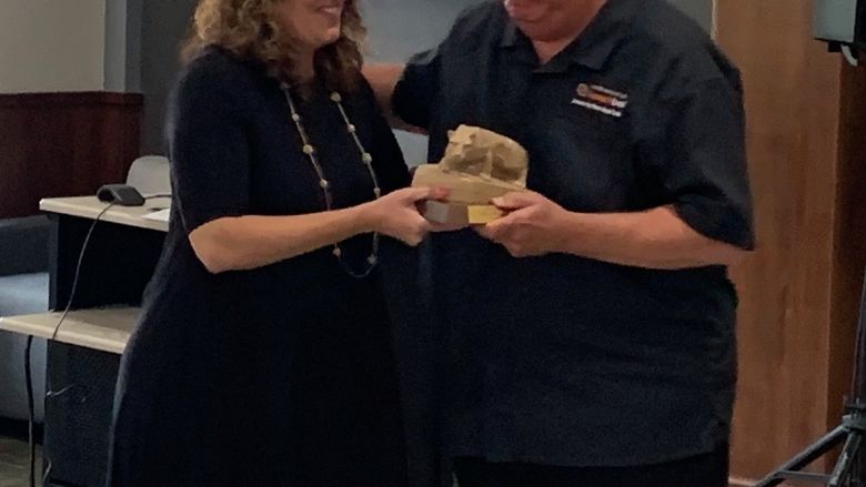 DEF President Kristen Vida recently presented Penn State DuBois Chancellor M. Scott McBride with a Nittany Lion statue recognizing his service to the campus. 