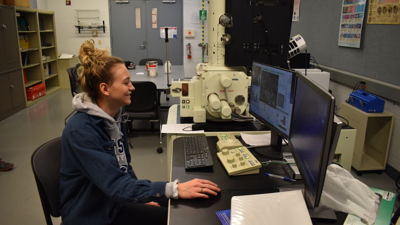 Penn State DuBois Engineering Student Nicolette Brossard examines properties of powder metal material under a scanning electronic microscope. 