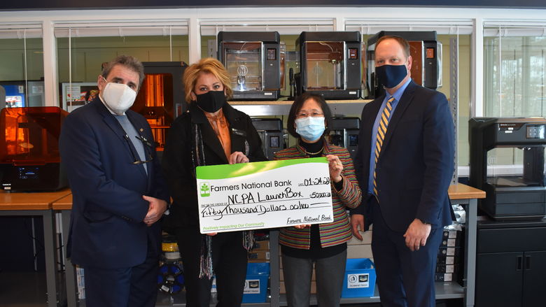 Farmer National Bank presents a $50,000 gift to NCPA LaunchBox. 