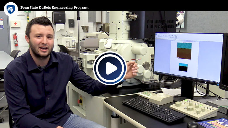 Student showing a scanning electron microscope.