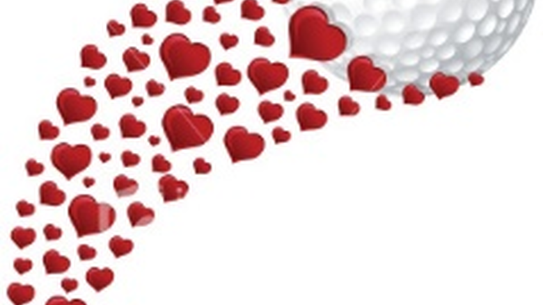 golf ball with a stream of red hearts