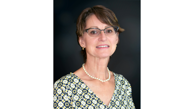 A woman wearing glasses and a necklace