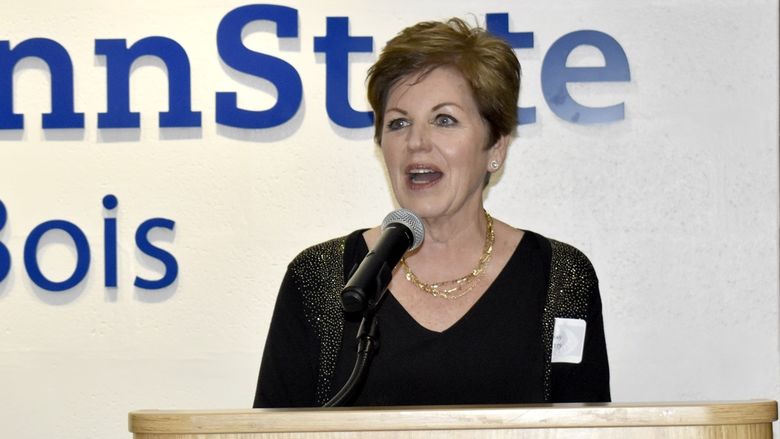 A person speaking into a microphone
