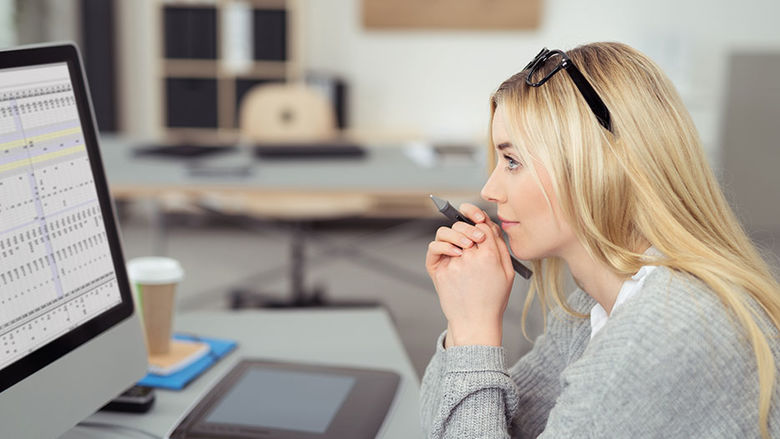 Girl looking at a spreadsheet on a computer screen