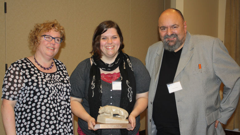 Outstanding Young Alumni Jessica Noland '14 receives her award from Tony Vallone and Jackie Atkins