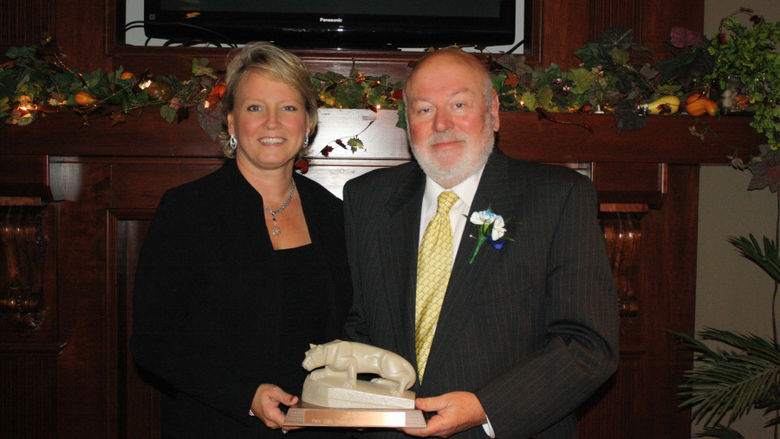 John Beam accepting the 2013 Distinguished Ambassador Award from Jean Wolf