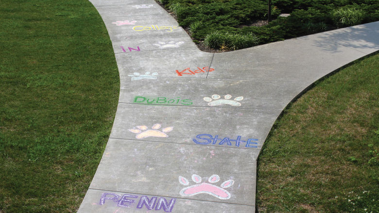 Penn State DuBois sidewalk with chalk drawings from Kids in College