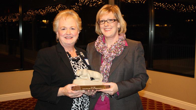 Carrie Wood '02 accepting the 2012 Outstanding Young Alumni Award from Lois Richards
