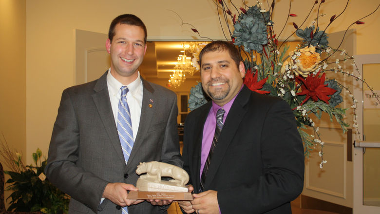Matt Gabler receiving the Distinguished Ambassador Award from Nick Suplizio '02
