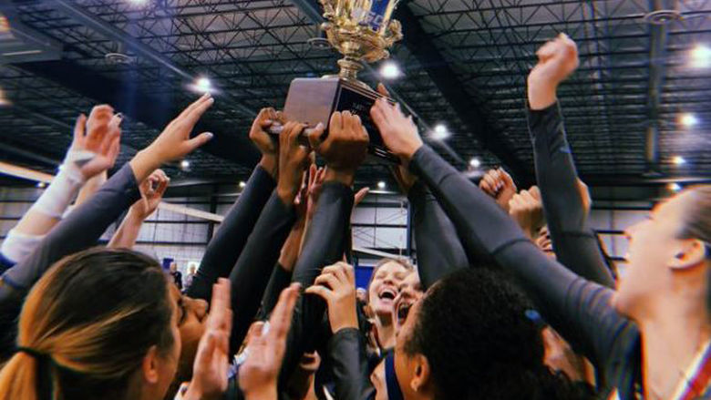 Penn State Fayette's volleyball team holds up a trophy
