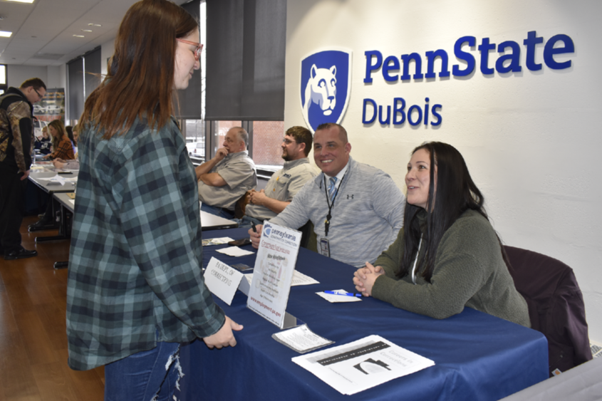 Student talks with employers at career event