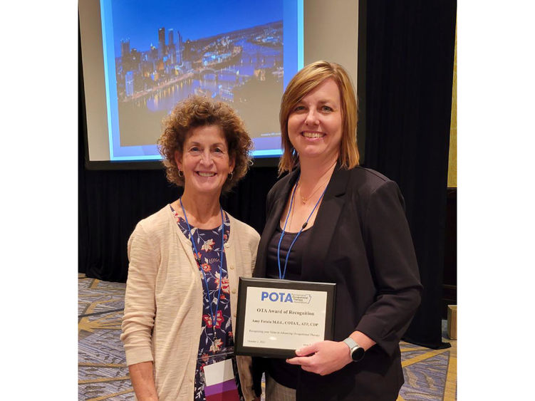 LuAnn Delbrugge with Amy Fatula with her OTA Award of Recognition at the 2022 POTA conference.