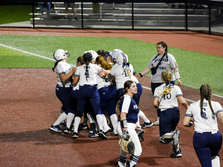 The Penn State DuBois softball team rush the field to celebrate a walk off win against Penn State Fayette at Heindl Field in DuBois