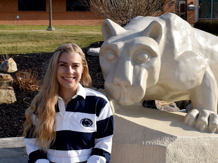 Larissa James-LaBranche with the Lion Shrine on the campus of Penn State DuBois