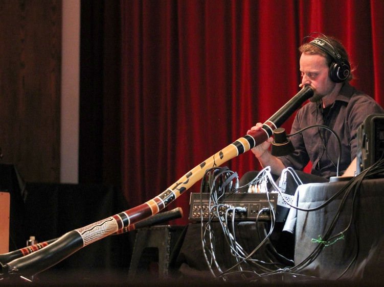 Didge Evolution’s Rob Thomas plays a didgeridoo.