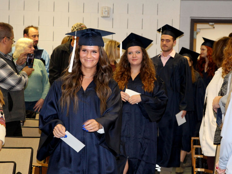 Graduates enter Hiller Auditorium during the processional at the beginning of the commencement celebration at Penn State DuBois.