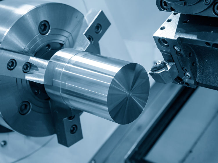 A CNC lathe machine preparing to cut a metal part.