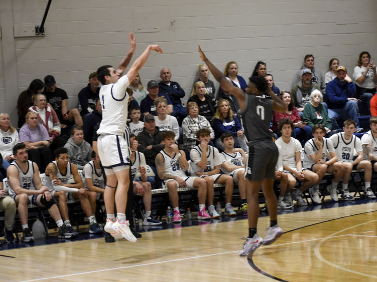 Penn State DuBois sophomore guard Christopher Frontera attempts a three-point shot over a Greater Allegheny defender during the game at the PAW Center