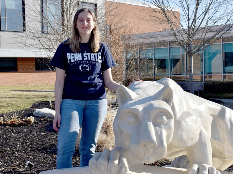 Taylor Charles next to the Nittany Lion shrine on the campus of Penn State DuBois