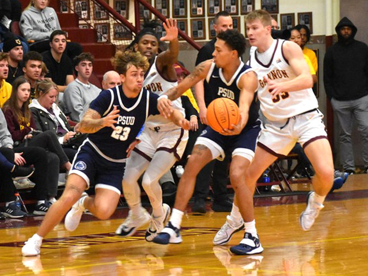 Penn State DuBois junior forward Ashton Fortson hands the ball off to junior guard Jordin Sommers during a basketball game earlier in the season.