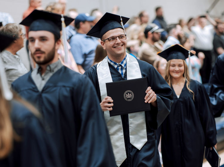 Three graduates in regalia 