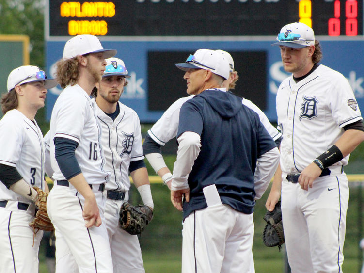 Penn State DuBois head coach Tom Calliari, center, talks with his players during a mound visit in a game during the USCAA Small College World Series.