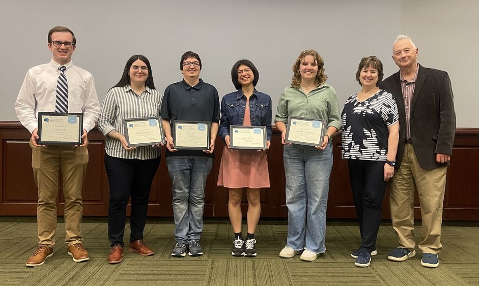 5 students holding awards standing next to John Sr. and Kimlyn Patishnock 