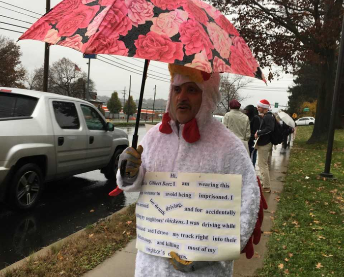Students displayed signs along Route 255 in front of campus during a reintegrative shaming exercise.