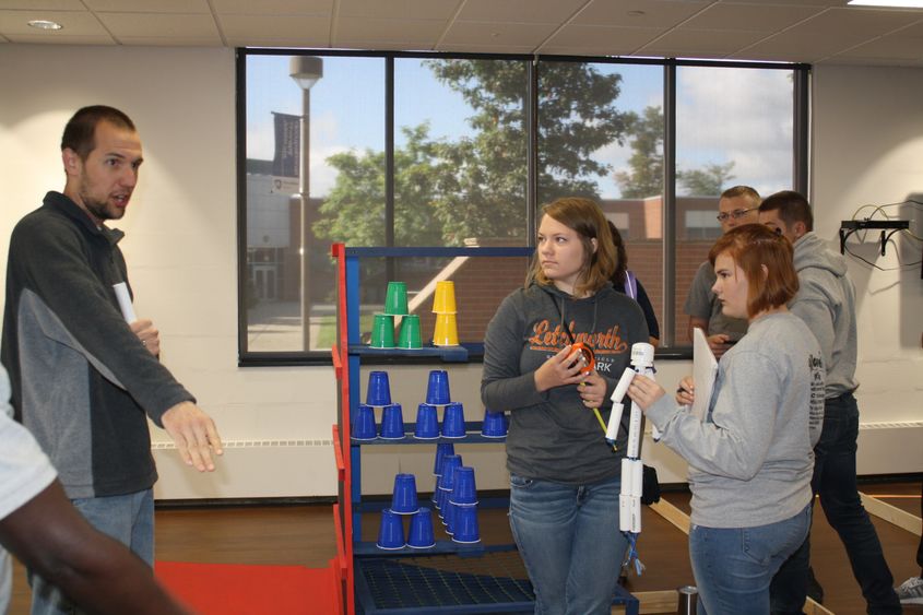 Penn State DuBois engineering student Kurt Diehl, left, presents a portion of the BEST Robotics course